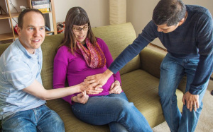 Image of an LGBT couple with surrogate mother