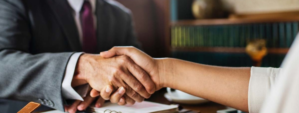 Image of an attorney and client shaking hands
