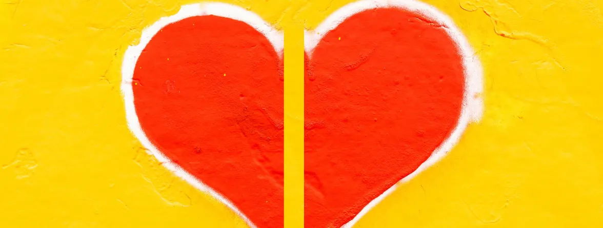 An image of a heart split in half, with a white design along the edges, on a yellow background