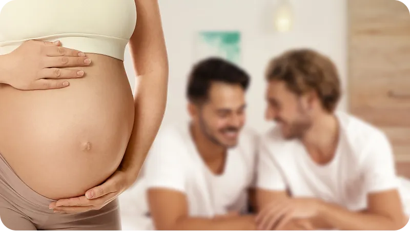 The joy of expectant fathers is subtly shown behind the pregnant belly of a woman.