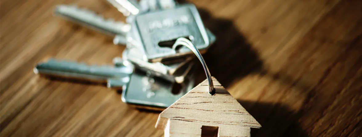 A bunch of keys with a house-shaped keychain