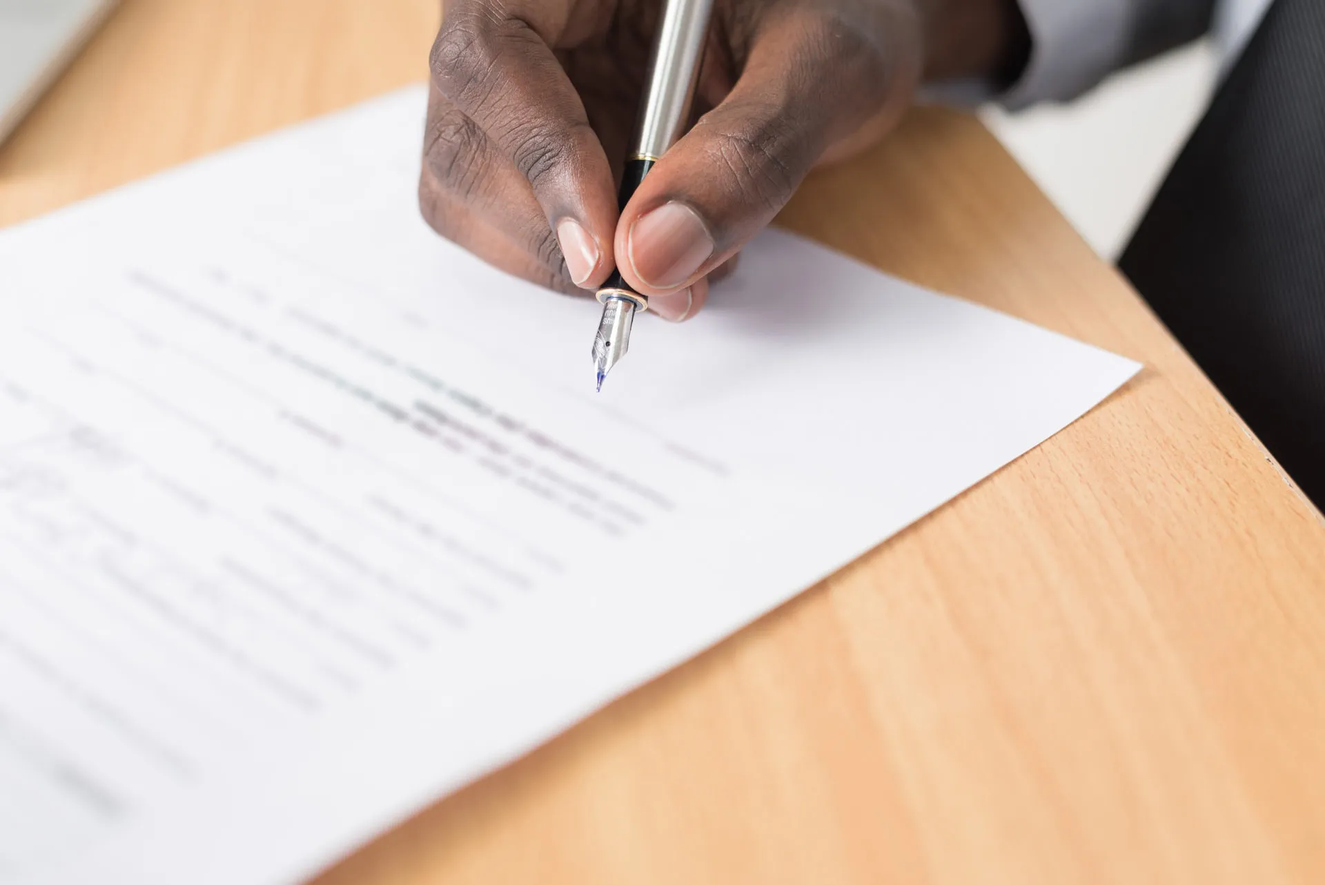 A man writing and filling out a paper.