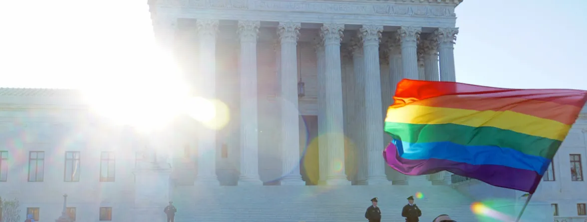 An image of a building representing ‘Equal Justice Under Law,’ with men outside, one of whom is waving a rainbow flag.